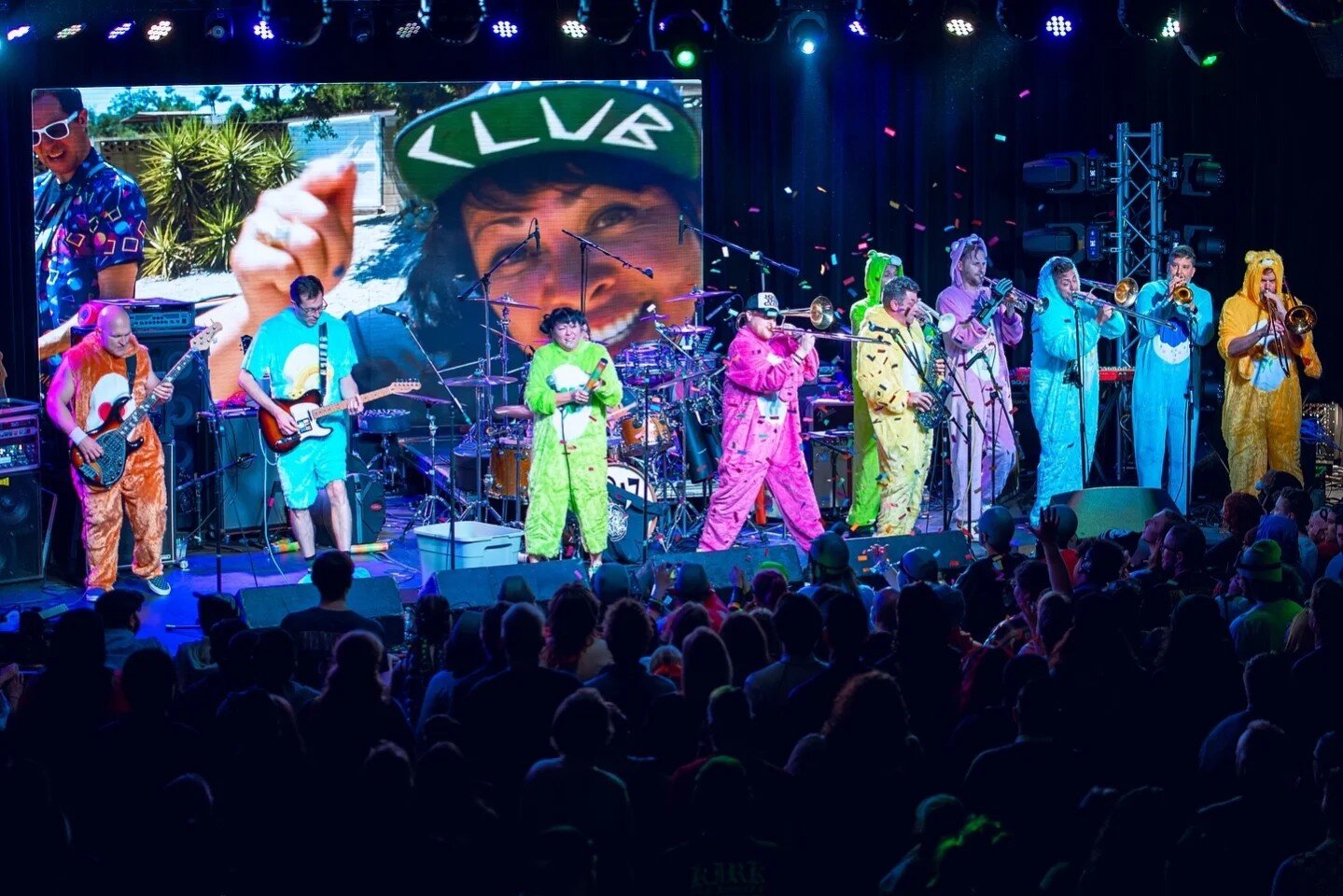 The Goodwin Club performing in colorful animal onesies.